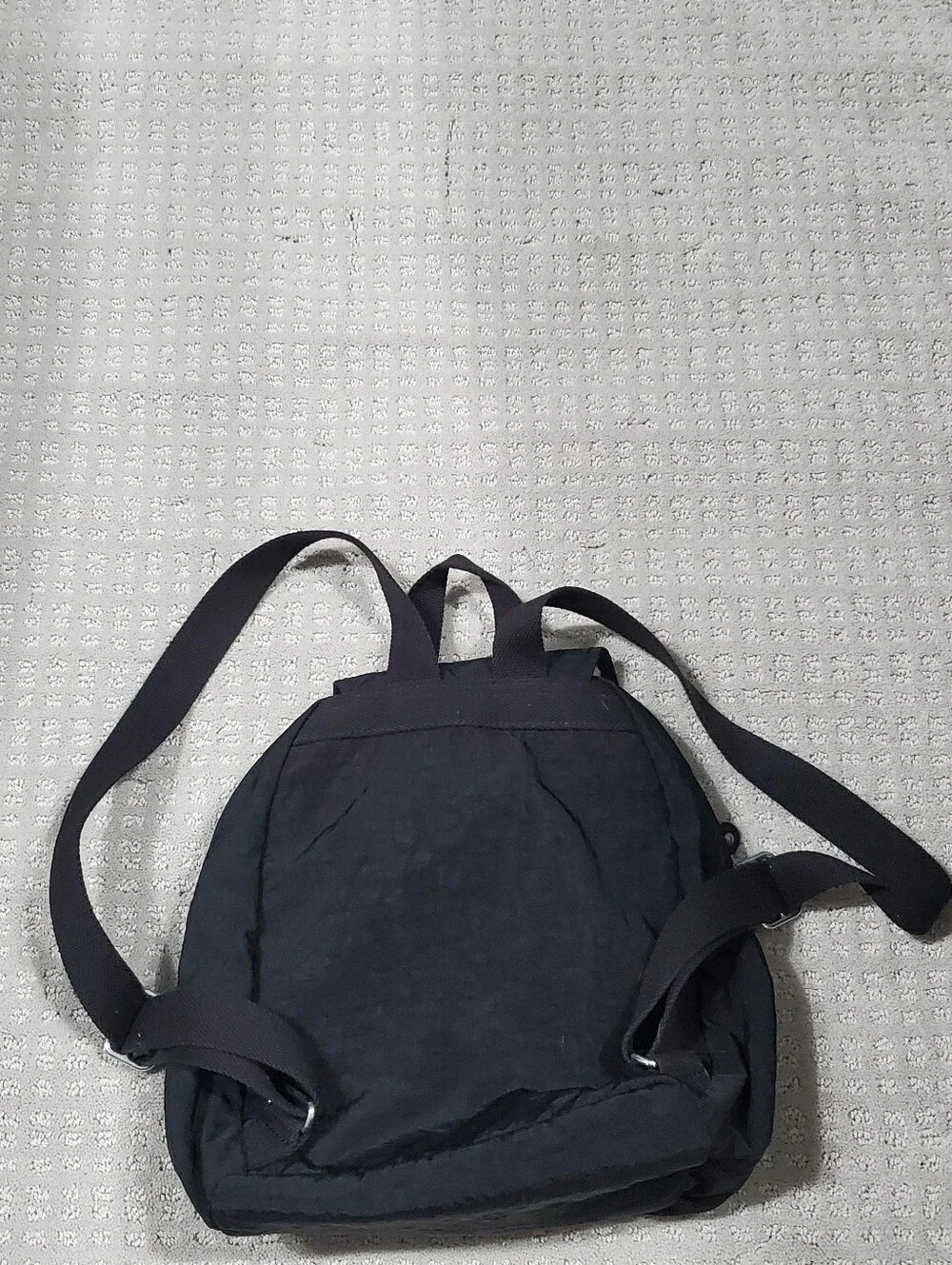 Kipling Queenie Small Backpack Black Nylon Brand Logo on the front flap.